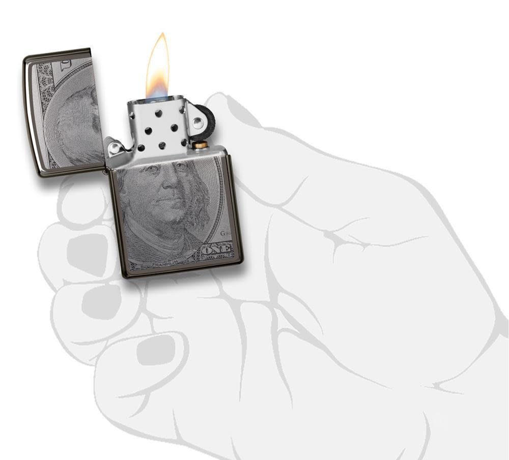 Front view of the Currency Design Lighter open, in hand and lit