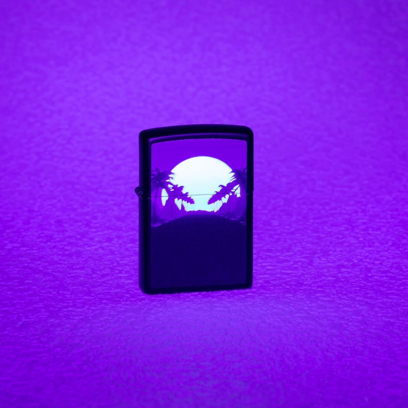 Lifestyle image of Sunset Black Light Design Black Lighter Black Matte Windproof Lighter showing the blacklight design.