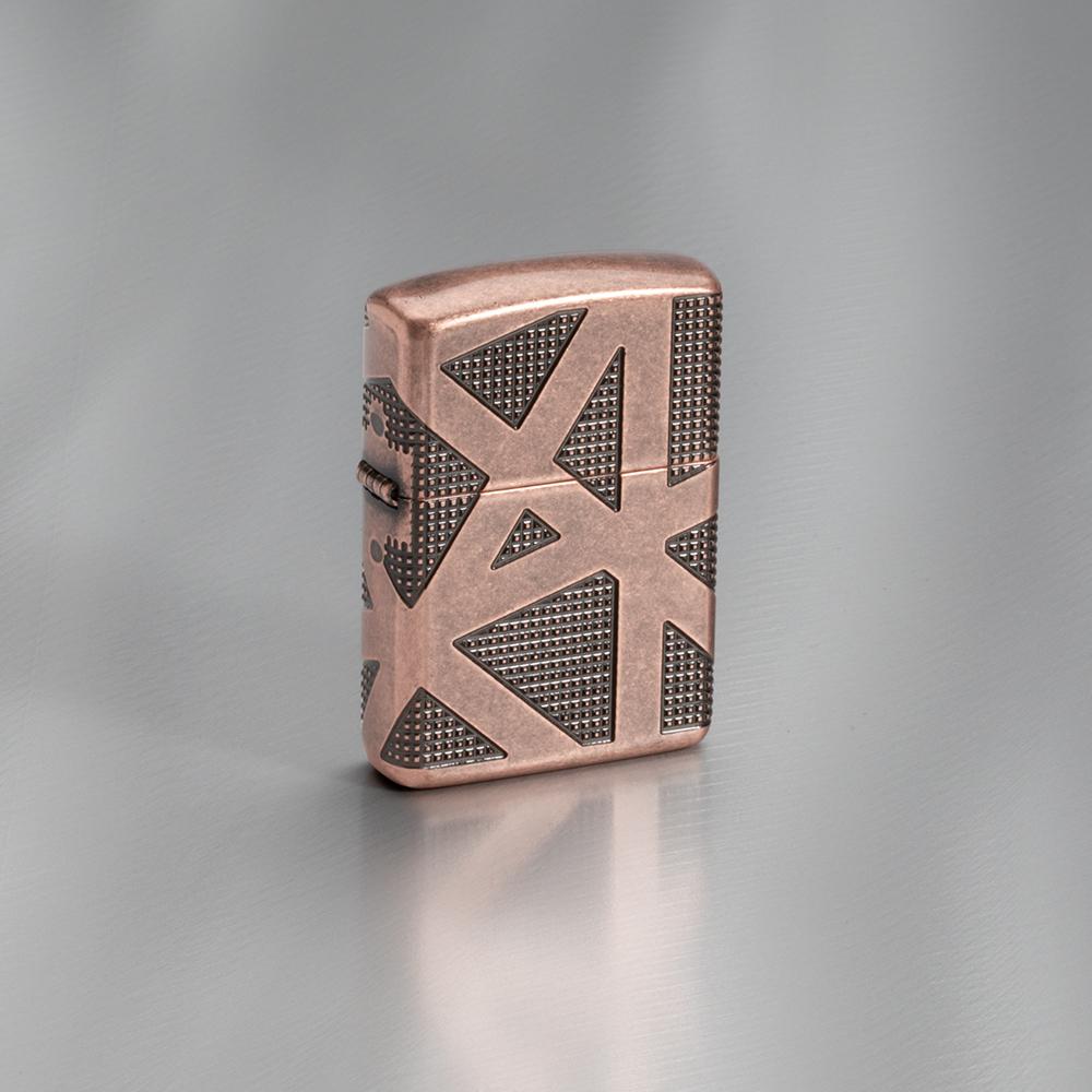 Lifestyle image of Armor® Geometric 360 Design Windproof Lighter standing on a grey surface