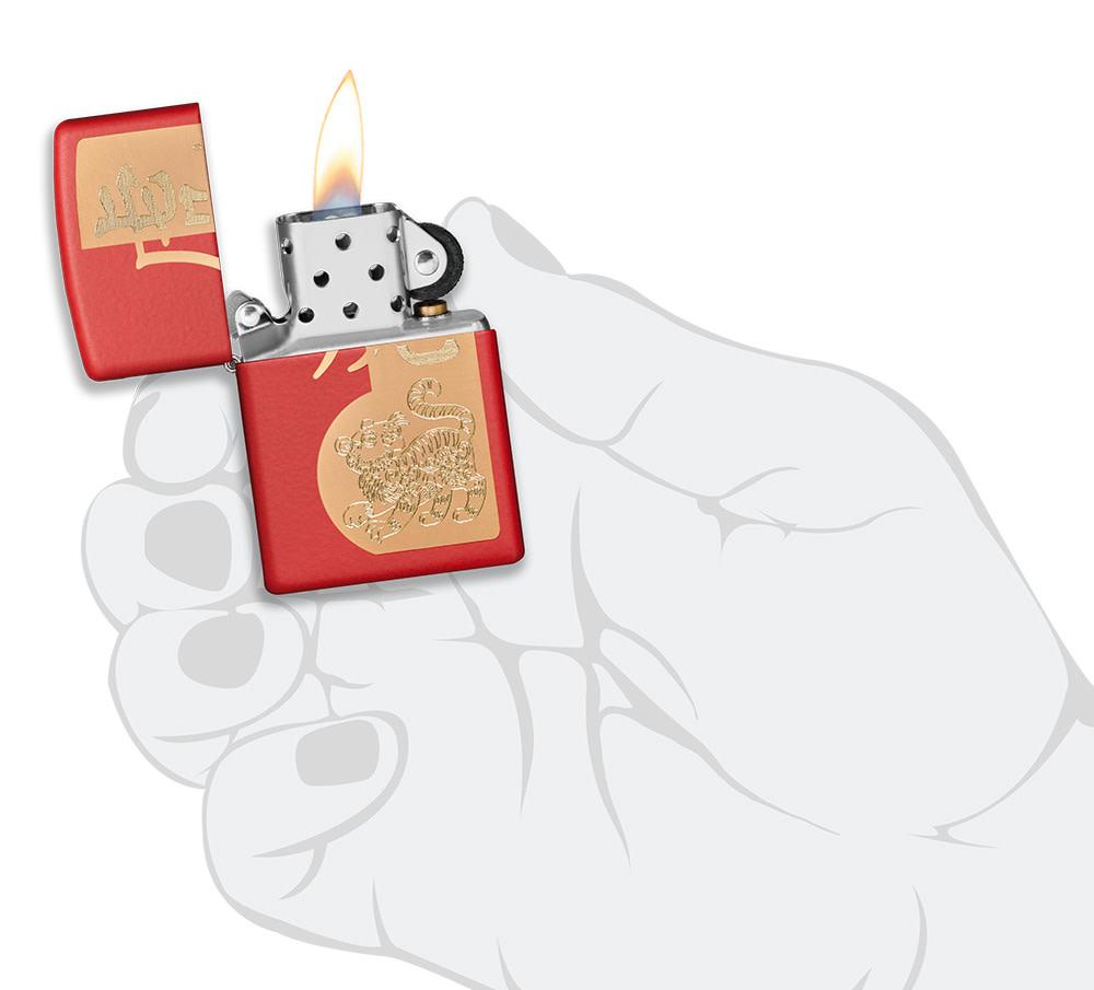 Year of the Tiger Design Red Matte Windproof Lighter lit in hand.