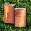Woodchuck USA Cedar Windproof Lighter on grass background