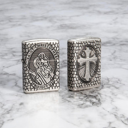 Lifestyle image of Armor St. Christopher Medal Antique Silver Windproof Lighter standing on a marble surface