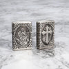 Lifestyle image of Armor St. Christopher Medal Antique Silver Windproof Lighter standing on a marble surface
