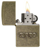 Zippo Stamp Antique Brass Lighter with its lid open and lit.