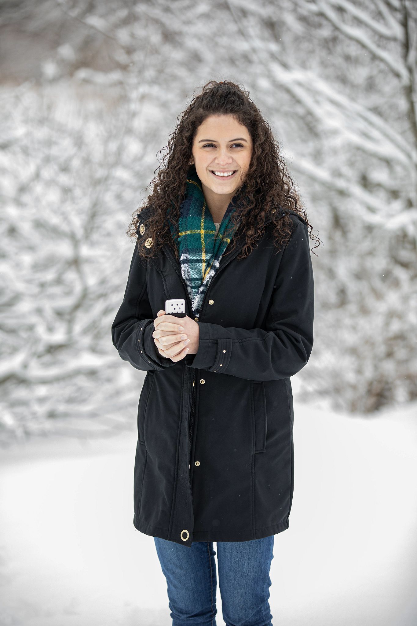 Lifestyle Image of woman holding a High Polish Chrome 6-Hour Refillable Hand Warmer, outside in the cold