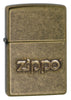Front shot of Zippo Stamp Antique Brass Lighter standing at a 3/4 angle.