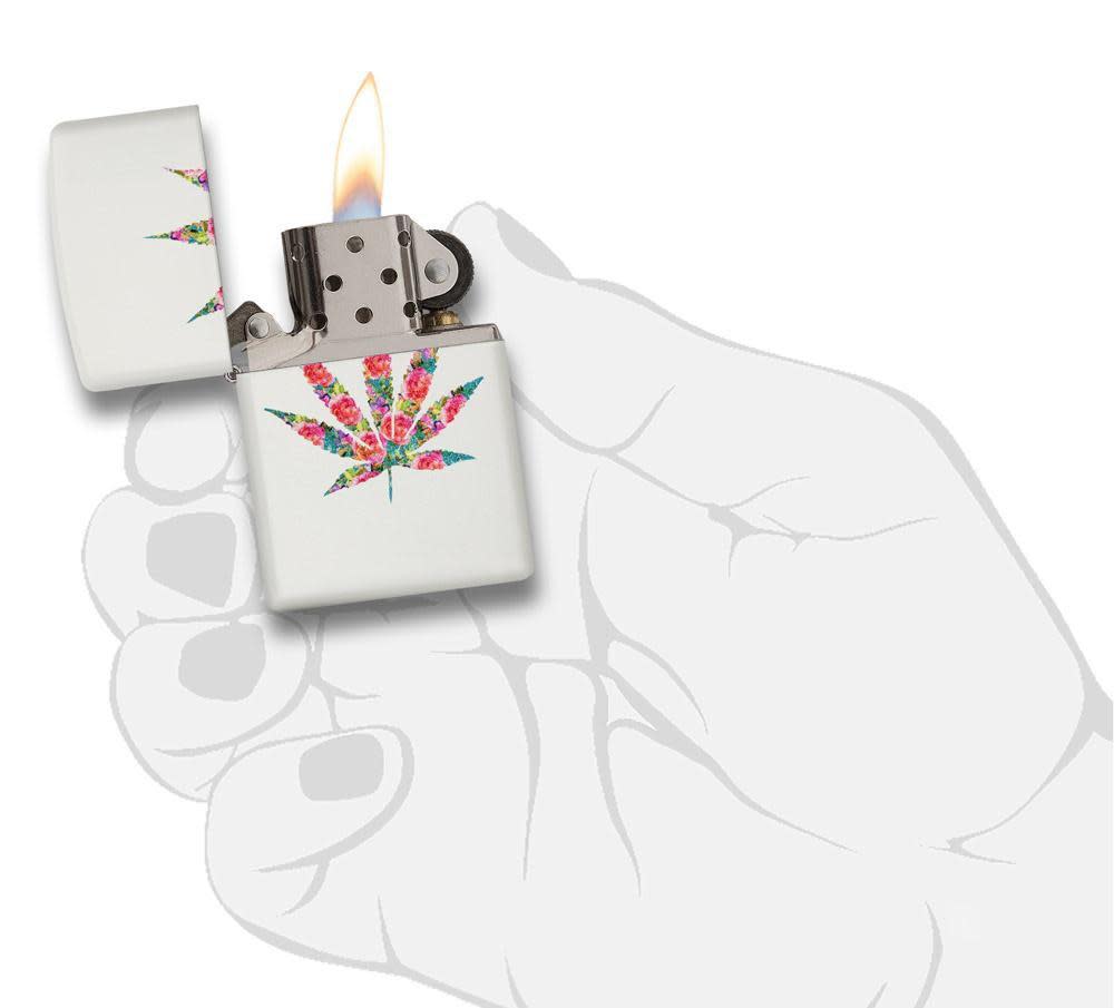 Floral Weed Design White Matte Windproof Lighter lit in hand.