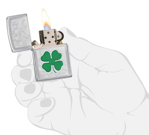 Front view of the Green & Silver Shamrock High Polish Chrome Lighter in hand, open and lit