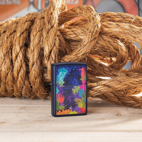 Lifestyle image of Sea Life Design Navy Matte Windproof Lighter, standing in front of rope.
