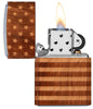 WOODCHUCK USA American Flag Wrap Windproof Lighter with its lid open and lit