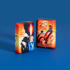 Lifestyle image of two Mazzi® 25th Anniversary 540 Color Windproof Lighters standing in a blue background. One lighter showing the front of the design and the other showing the back.